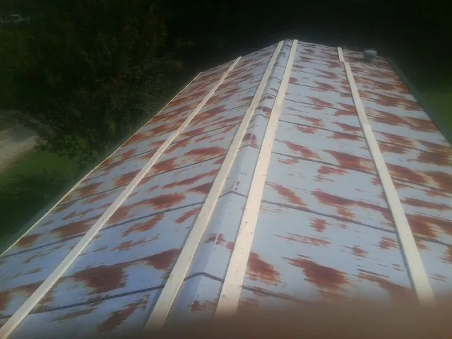 Rusted metal roof panels with new wood purlins before replacement — Storm Damage Roof Repair in Harrisville by Roofing Brothers