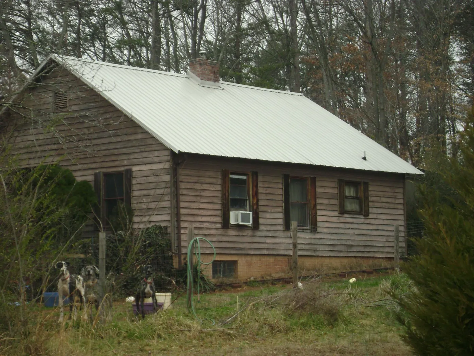 White metal roof on an old wood sided farmhouse, from a Metal Roof Installation job in Harrisville